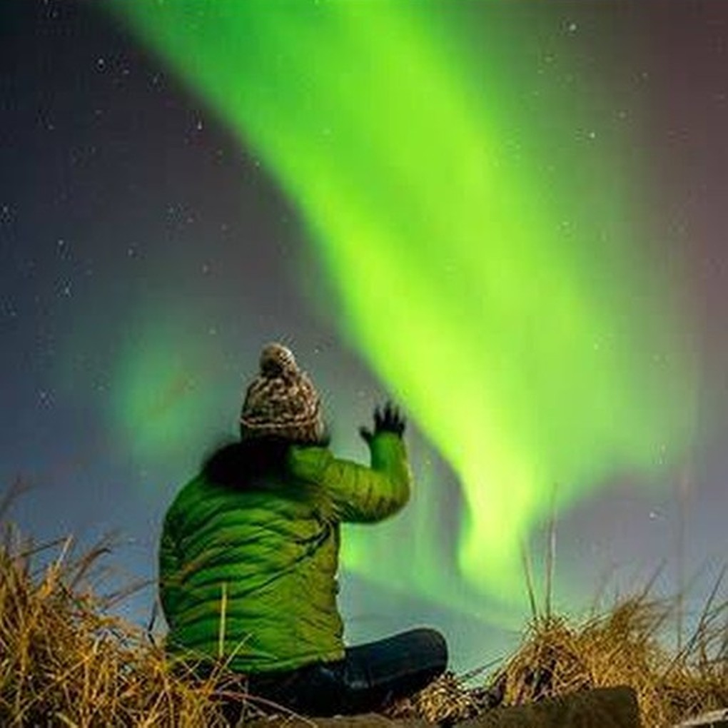 Northern lights glowing over a dark landscape