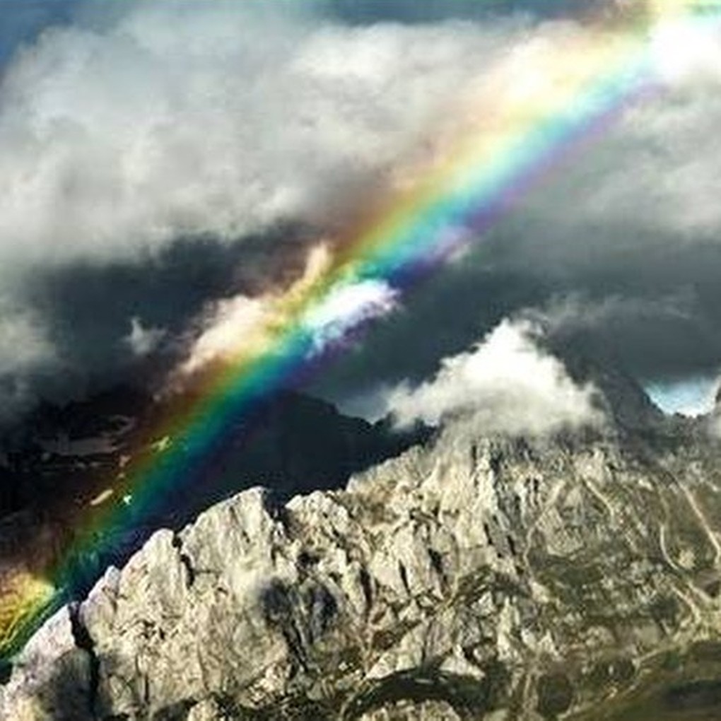Rainbow arching over a mountain landscape